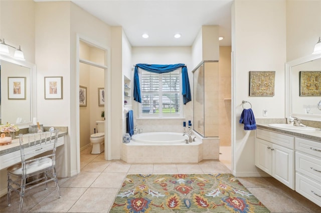 bathroom with a garden tub, tile patterned floors, toilet, vanity, and walk in shower