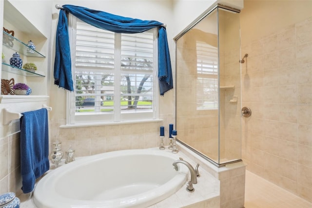 bathroom featuring a walk in shower and a garden tub