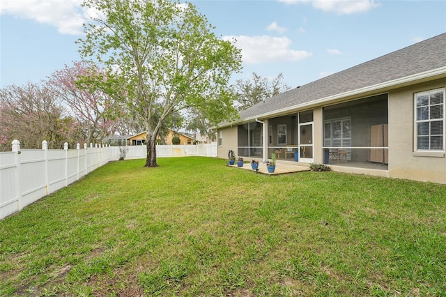 view of yard with a sunroom, a patio area, and a fenced backyard