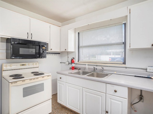 kitchen with white range with electric cooktop, white cabinets, light countertops, black microwave, and a sink