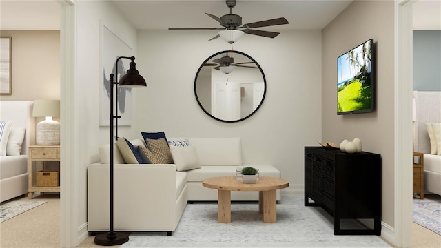 sitting room with ceiling fan and baseboards