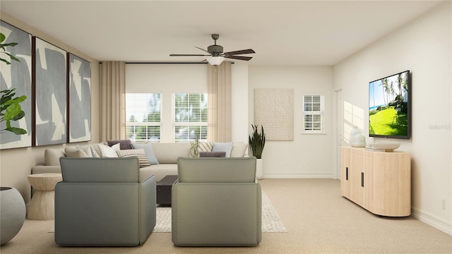 living area with ceiling fan, light carpet, and baseboards