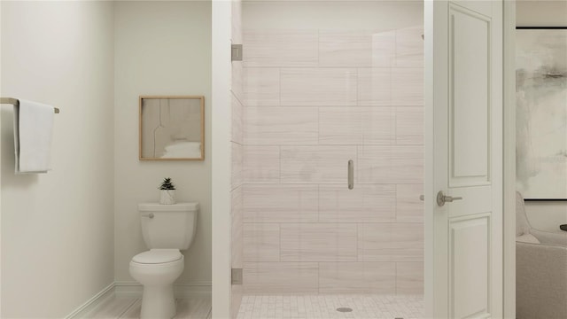 full bathroom featuring a closet, a shower stall, toilet, and baseboards