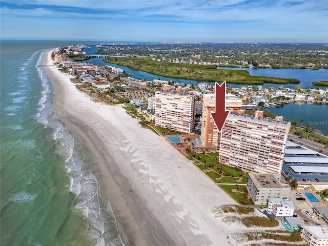 drone / aerial view featuring a view of city, a water view, and a beach view