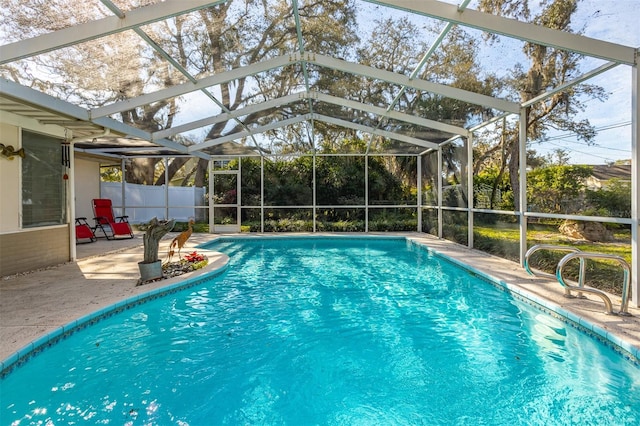 view of pool with a fenced in pool, glass enclosure, a patio, and fence