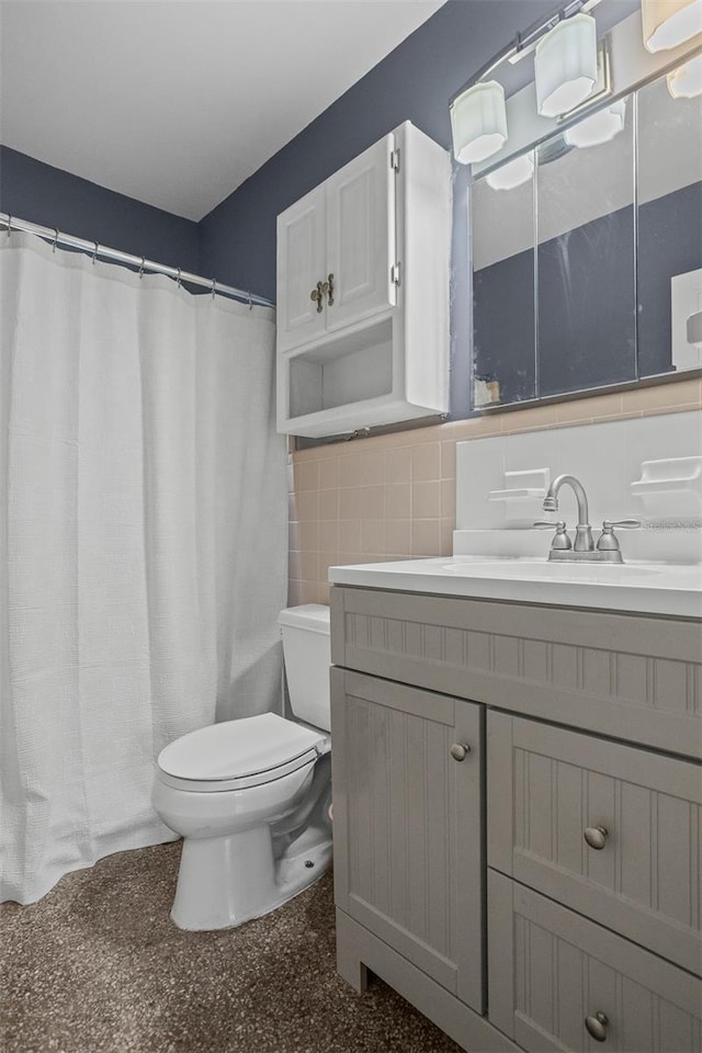 full bath with tile walls, curtained shower, toilet, vanity, and speckled floor