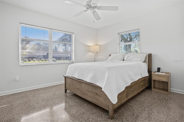 bedroom with ceiling fan and baseboards