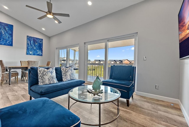 living area featuring lofted ceiling, ceiling fan, light wood-style flooring, recessed lighting, and baseboards