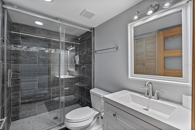 full bath featuring a stall shower, visible vents, vanity, and toilet