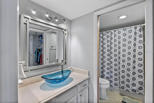 bathroom featuring toilet, tile patterned flooring, and vanity