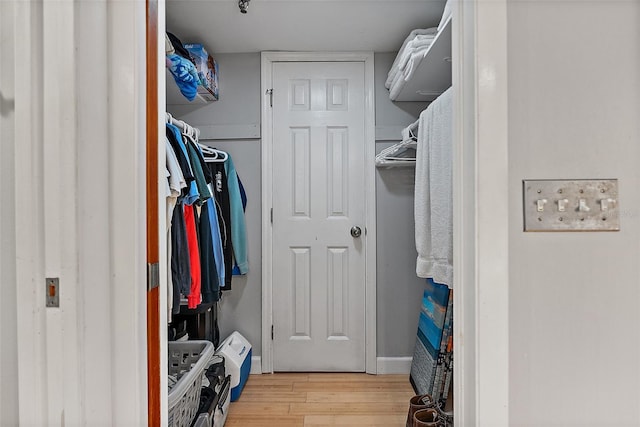 walk in closet featuring light wood finished floors