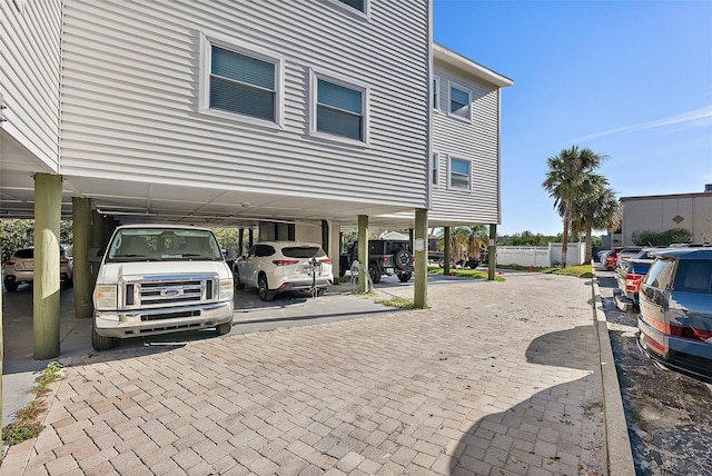 view of vehicle parking featuring fence