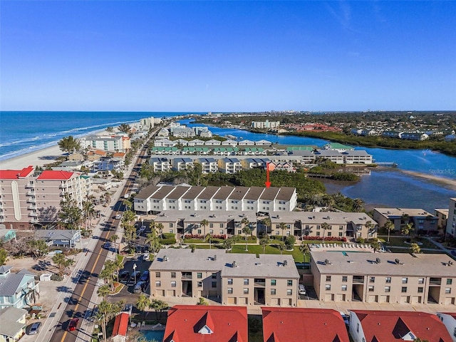 drone / aerial view with a water view and a beach view