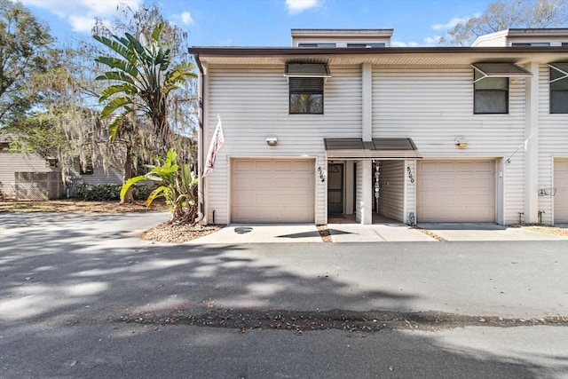 multi unit property featuring an attached garage