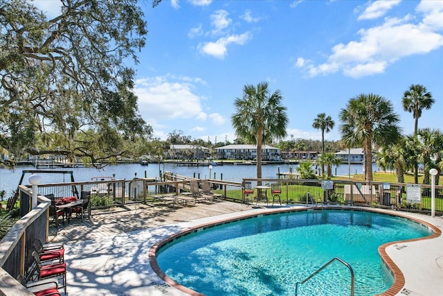 pool with fence and a water view