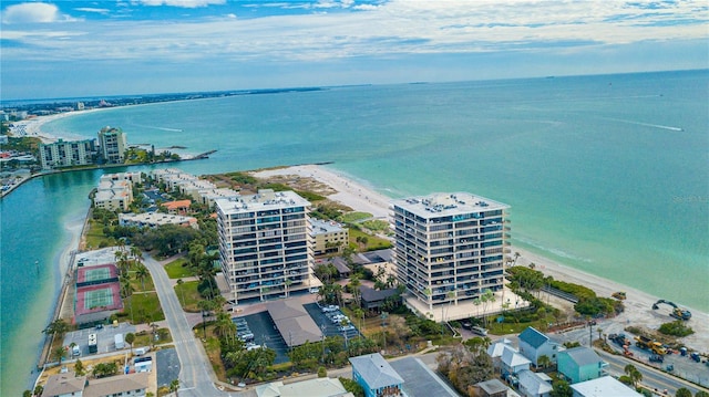 birds eye view of property with a water view, a beach view, and a city view