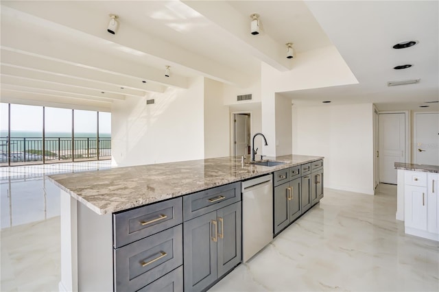 kitchen featuring a center island with sink, visible vents, dishwasher, a water view, and a sink