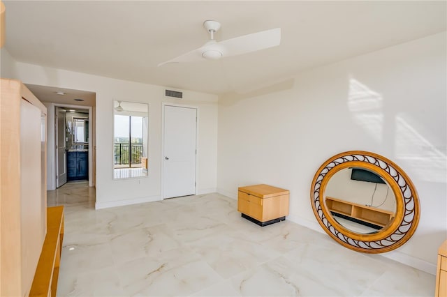 living area with marble finish floor, baseboards, visible vents, and a ceiling fan