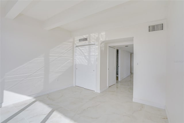 additional living space featuring marble finish floor, baseboards, visible vents, and beamed ceiling