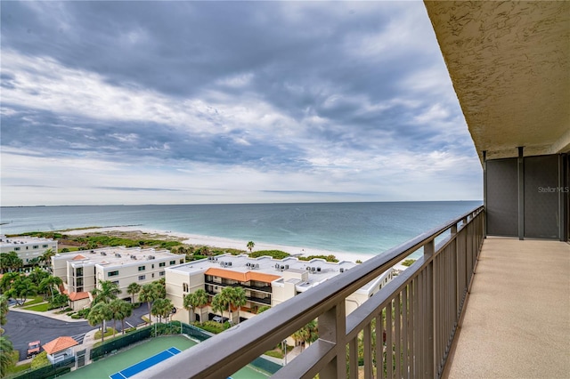 balcony with a view of the beach and a water view