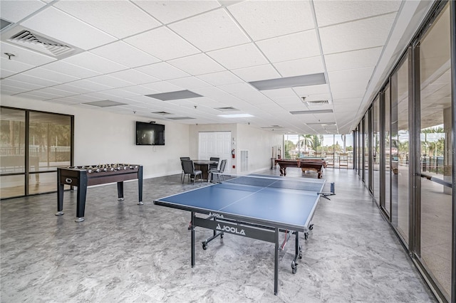 playroom with a paneled ceiling, visible vents, and a wealth of natural light