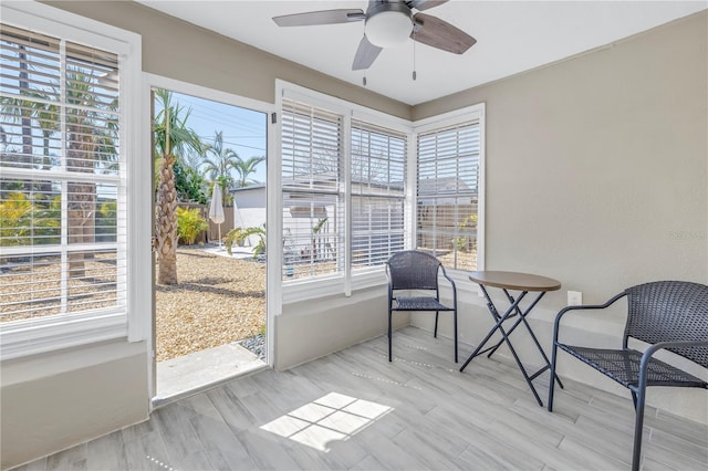 sunroom with ceiling fan and plenty of natural light
