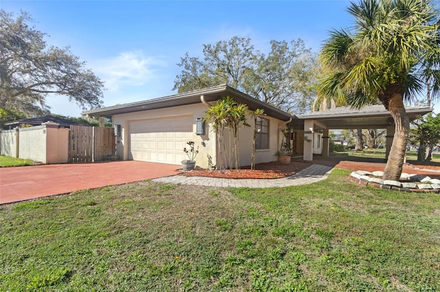 view of front of property with an attached garage, fence, driveway, stucco siding, and a front yard