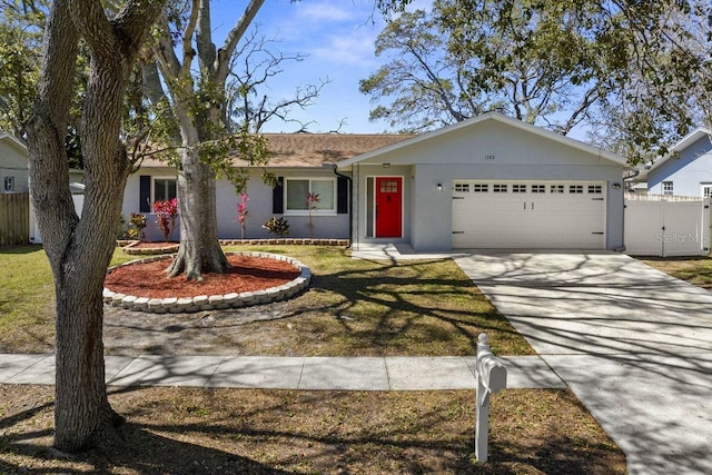 ranch-style home with concrete driveway, an attached garage, and stucco siding