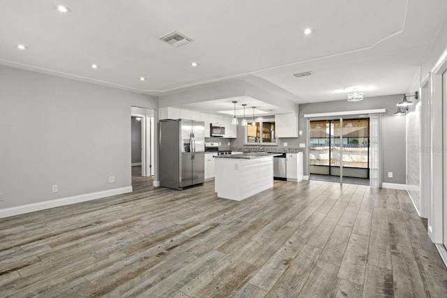 kitchen with light wood finished floors, a center island, stainless steel appliances, white cabinetry, and pendant lighting