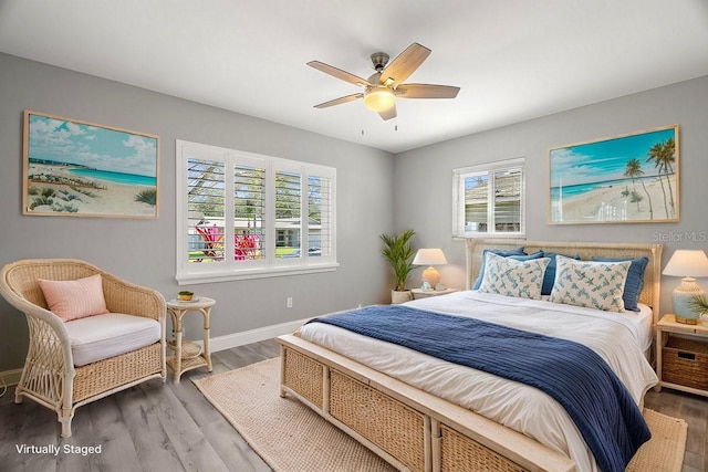 bedroom with ceiling fan, wood finished floors, and baseboards