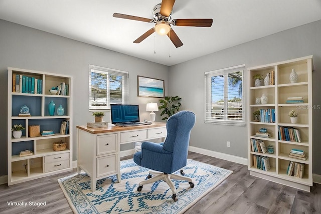 office space with a healthy amount of sunlight, baseboards, and wood finished floors