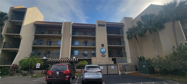 view of building exterior featuring uncovered parking