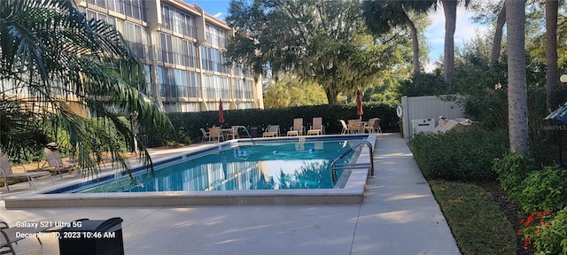 community pool featuring fence and a patio