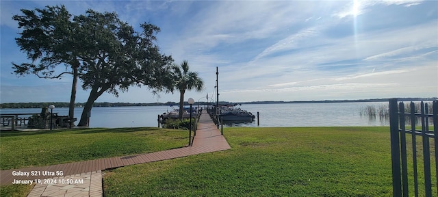 dock area featuring a water view and a yard