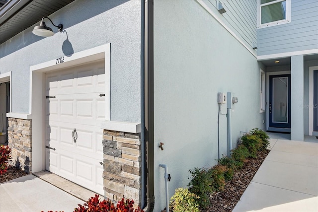 entrance to property featuring stone siding and stucco siding