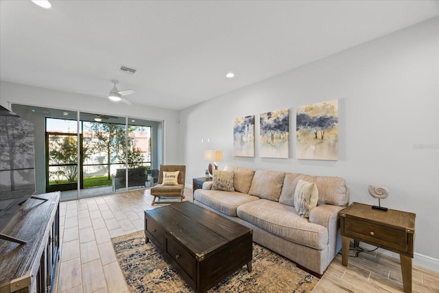 living room featuring a ceiling fan, wood tiled floor, visible vents, and recessed lighting