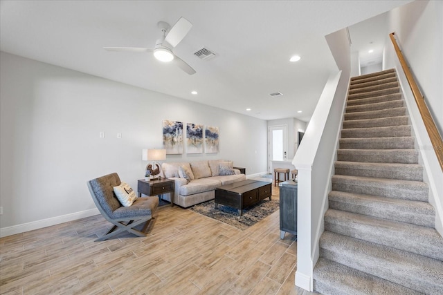 living area with stairway, recessed lighting, visible vents, and light wood-style flooring