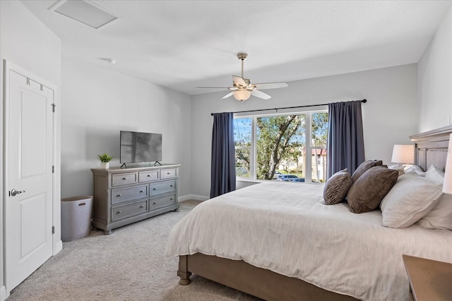 bedroom with a ceiling fan, light colored carpet, visible vents, and baseboards