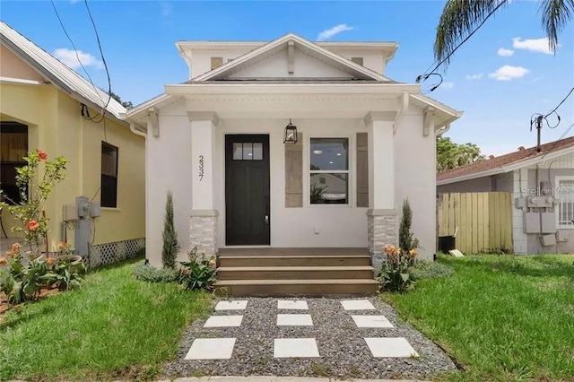 doorway to property with a yard and stucco siding