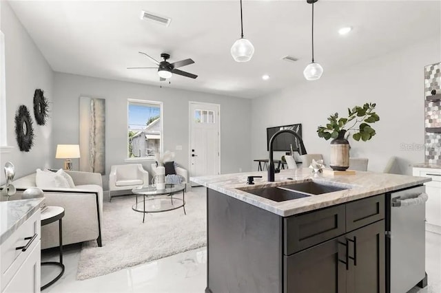 kitchen with visible vents, dishwasher, open floor plan, pendant lighting, and a sink