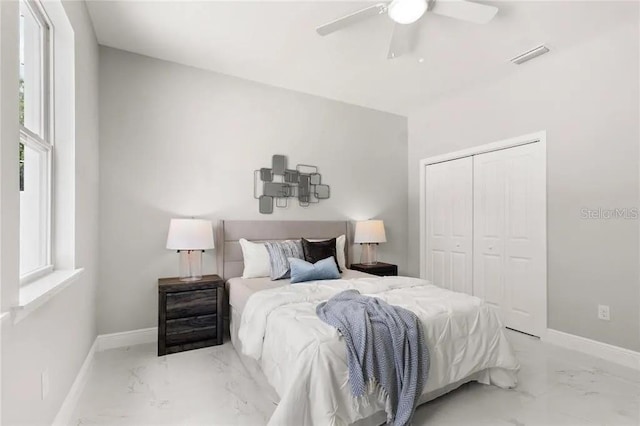 bedroom featuring marble finish floor, visible vents, and baseboards