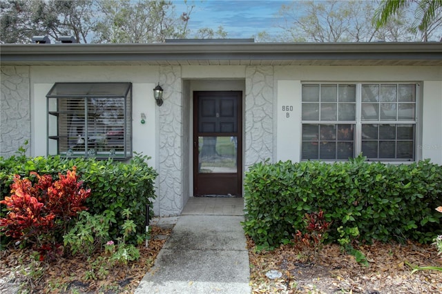 doorway to property with stucco siding