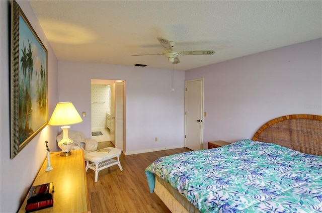 bedroom with baseboards, visible vents, ceiling fan, a textured ceiling, and light wood-style floors