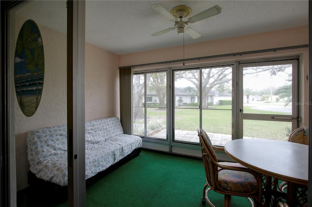 sunroom with a ceiling fan