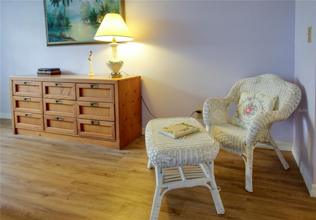 sitting room featuring light wood-type flooring and baseboards