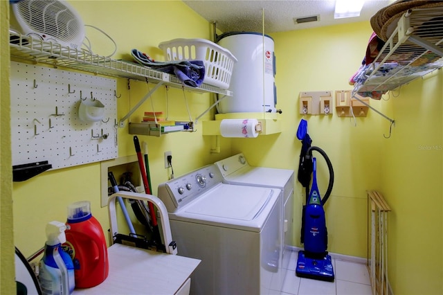 washroom featuring visible vents, a textured ceiling, separate washer and dryer, tile patterned flooring, and laundry area