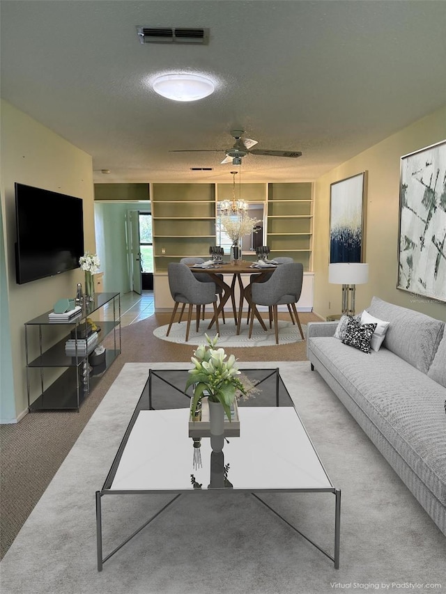860 Glen More Ct Unit B, Palm Harbor, FL 34684 - living area with a textured ceiling, visible vents, built in shelves, a chandelier, and carpet