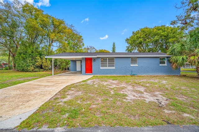 ranch-style house featuring an attached carport, concrete driveway, a front lawn, and stucco siding