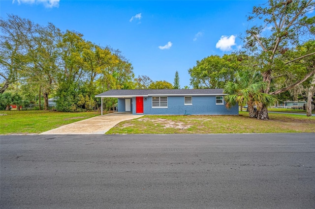 single story home featuring driveway, a front lawn, and an attached carport