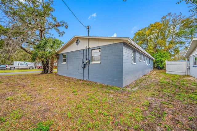 view of side of property featuring a yard and fence